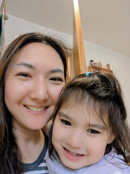 Woman pictured with her daughter smiling