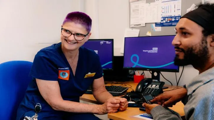 Nurse smiling interacting with a patient