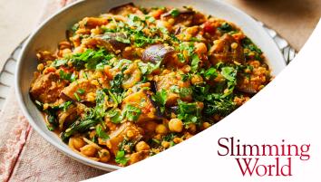 A white bowl filled with aubergine and lentil curry, topped with fresh coriander