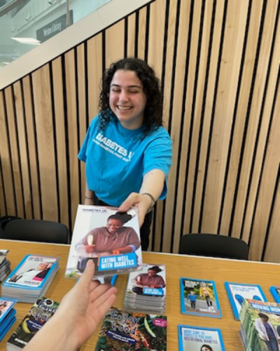 Sarah giving out leaflets at Diabetes UK event stand