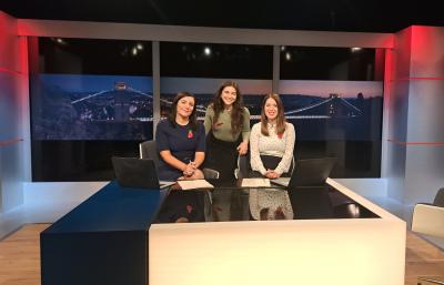 Megan stood in ITV studio with two presenters.