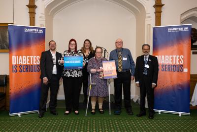 A group of people in front of Diabetes is Serious banners